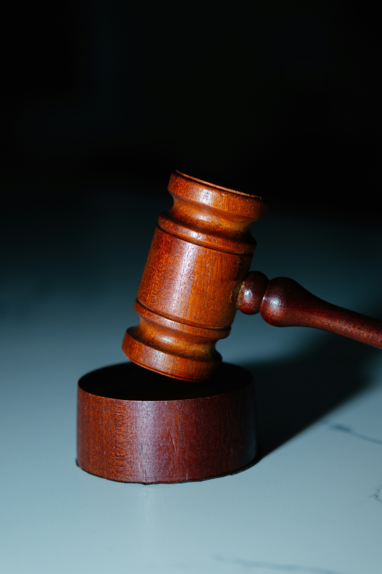 Wooden gavel resting above its sound block